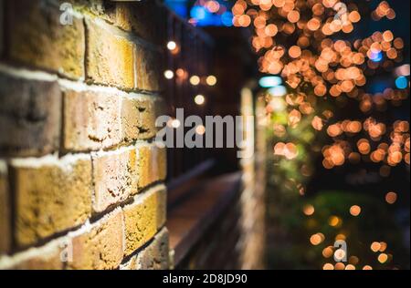 vintage brick wall Christmas background with lights glowing Stock Photo