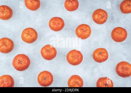 Tangerines laid out on a gray table, top view. Stock Photo