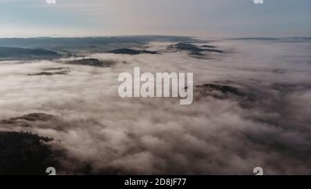 Aerial view of morning foggy landscape. Fall autumn peaceful scenery. Misty calm atmosphere. Drone photo of Czech mountains. Trees in fog. Fairy tale Stock Photo