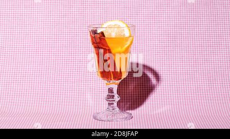 Hot Toddy cocktail drink with lemon on textile background. Retro style Stock Photo