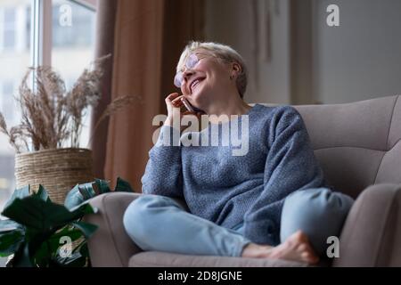 Senior woman talking on mobile phone at home Stock Photo