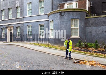 Road sweeper cleaning the leaves away from outside No. 10 Downing Street, westminster, london, uk Stock Photo