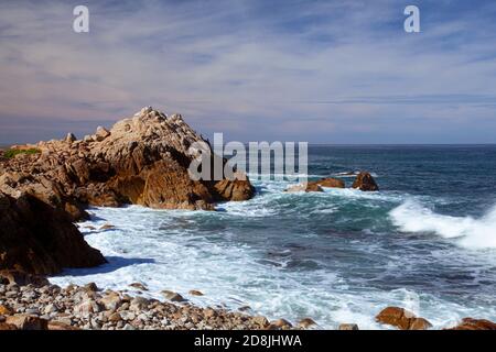 A rocky coastal landscape taken at a location near Point Lobos National Park in Northern California. Powerful waves of the Pacific Ocean are hitting o Stock Photo