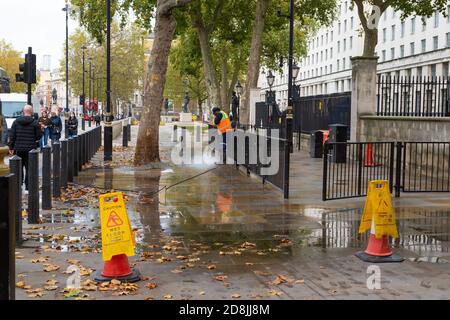 Jet washing the pavement, westminster, london, uk Stock Photo