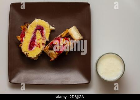 Close up image showing two thick slices of home made swiss roll cake filled with tasty fresh berries and finished with vanilla icing cream berry walnu Stock Photo