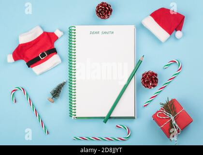Merry Christmas.Christmas concept background.Letter to Santa Claus with christmas decoration over blue background Stock Photo