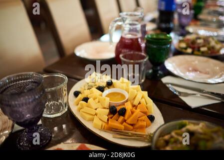 Cheese plate with different kinds of cheese with honey, grapes and straws Stock Photo