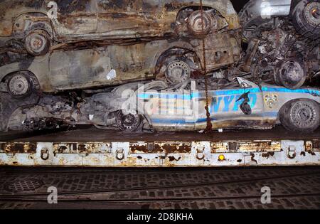 Vehicles that were crushed as a result of the collapse of the World Trade Center are brought to a temporary storage lot in Brooklyn on a flat-bed truc Stock Photo