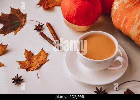 Pumpkin smoothie, spice latte. Boozy cocktail with cinnamon sticks anise stars. Maple leaves decorations. Autumn seasonal hot drinks. Stock Photo