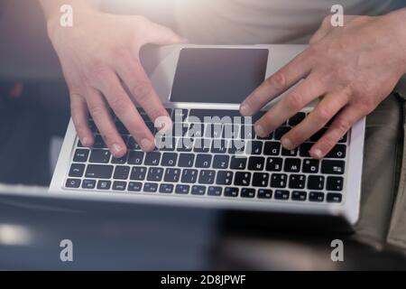 Mobile car service engineer checking car with his laptop on the road. Road assistance concept Stock Photo