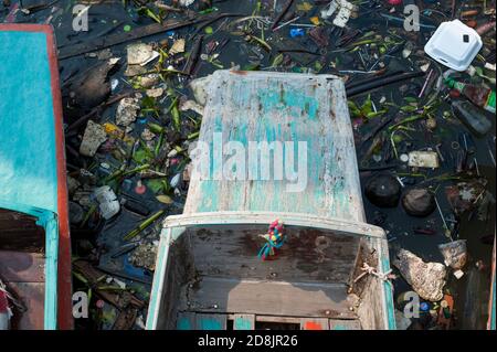 Wooden taxi boats surrounded by plastic waste and other garbage and debris at Chao Phraya River, Bangkok, Thailand / ecology plastic pollution concept Stock Photo