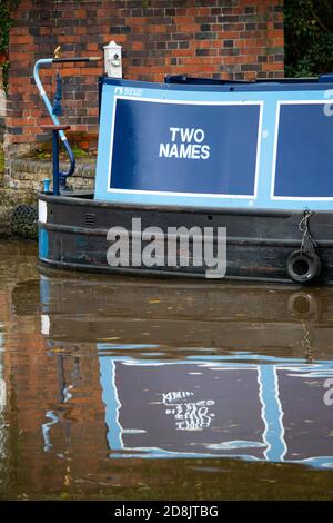 Canal boats on the Coventry canal in Atherstone, North Warwickshire. In October 2020 lock number two on the Atherstone flight of locks was broken resulting in boats being held up creating a queue of boats waiting to progress along the waterway. Stock Photo