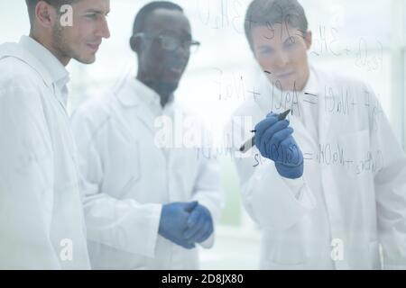 promising scientist makes notes on the Board Stock Photo