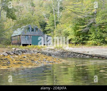 Old boat house in a small cove on the Atlantic Coast in Maine. Stock Photo