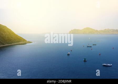 Mountains by the sea in the sun. Seascape with mountains and boats. Adventure and travel concept Stock Photo