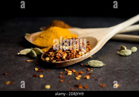 Wooden spoons with aromatic spices Stock Photo