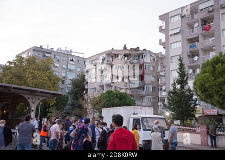 Izmir, Turkey - October 30, 2020: Building damaged in the earthquake in Manavkuyu District Bayrakli Izmir Turkey. With people outside Stock Photo