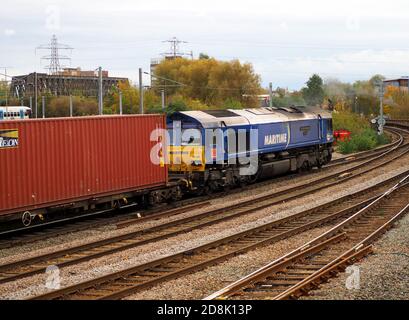 DB Schenker Class 66 Locomotive 66051 'Maritime Four' passes Peterborough on the East Coast Main Line hauling an intermodal freight train Stock Photo