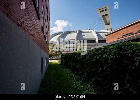 Part of the Olympic Stadium visible from a residential area in Hochelaga, Montreal, QC, Canada Stock Photo