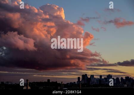 A candyfloss could passing over the silhouetted Montreal skyline, Quebec, Canada. Stock Photo