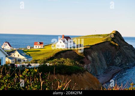 A Bonaventure Island and fisherman houses and Perce Rock in Gaspesie Stock Photo