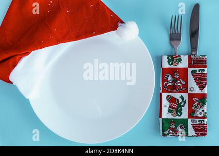 Xmas, winter, new year concept - layout white plate on which there are three Christmas trees cut from sausage cheese bread with santa hat and golden Stock Photo