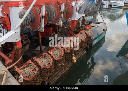 Rusty boat and nets for catching scallops Stock Photo