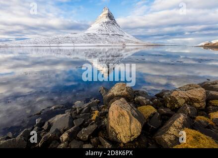 Dramatic Sky, Snow, and Reflection Landscape of Kirkjufell Mountain in Iceland's Snaefellsnes Peninsula Stock Photo