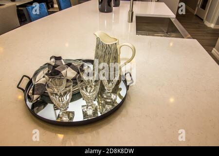 Metal Serving Tray With Pitcher & Glasses On Kitchen Island Counter Top Stock Photo