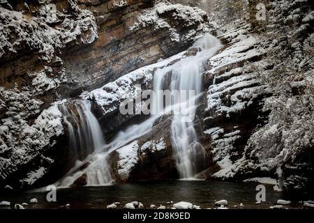Cameron Falls during the winter in Waterton Park after a snowfall. Stock Photo