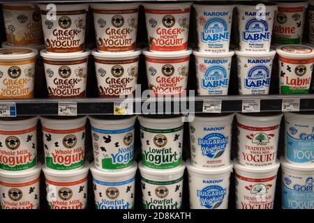 Containers of yogurt on a supermarket shelf Stock Photo