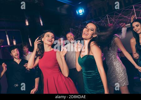 Attractive pretty smart elegant cheerful crowd people dancing chill rest relax having fun event in dark night club indoors Stock Photo