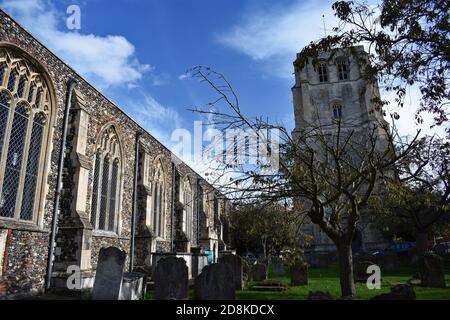 St Michaels Church in Beccles, Suffolk, England.  The free standing bell tower and surrounding graveyard can be seen around the old building. Stock Photo