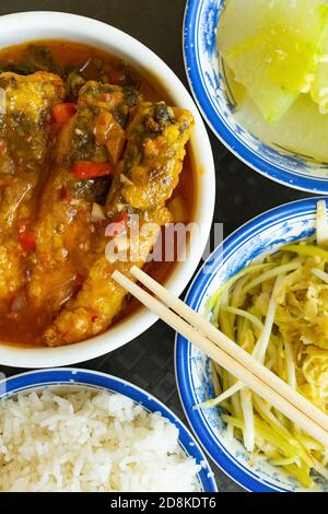 top view scrambled eggs with hotbed chives and deep fried fish and fuzzy melon with rice vertical composition Stock Photo