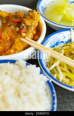 side view scrambled eggs with hotbed chives and deep fried fish and fuzzy melon with rice vertical composition Stock Photo