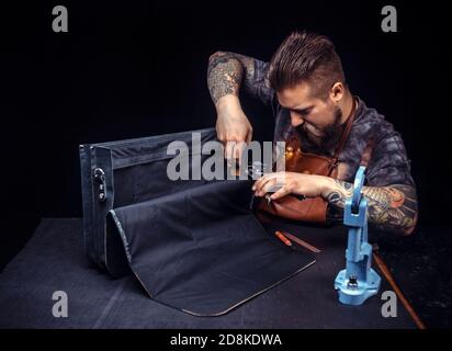 Handyman being keen on his buisness in his studio Stock Photo