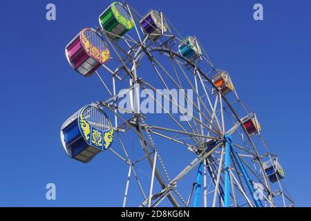 Close Up Low-Angle View of a Ferris wheel against Blue Sky Stock Photo