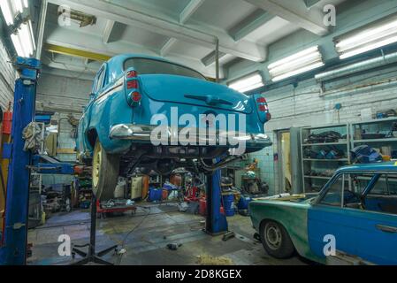SAINT PETERSBURG, RUSSIA - AUGUST 03, 2020: Soviet retro car 'Moskvich-403' on a lift in a car service. Back view. Restoration of retro transport Stock Photo