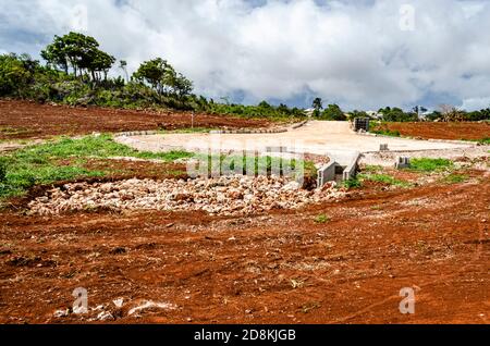 Installed as part of a road construction project is a water draining system equipted with water channel along the side of the roadway, and ends in a s Stock Photo