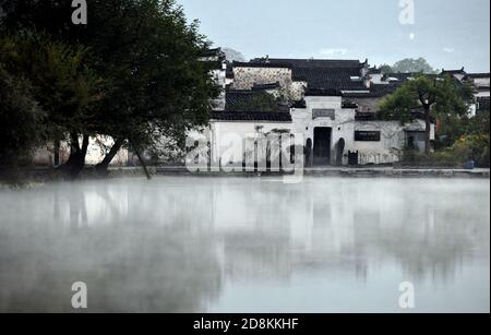 Beijing, China. 23rd Oct, 2020. Photo taken on Oct. 23, 2020 shows a morning view of Hongcun Village in Yixian County of east China's Anhui Province. With a history of over 800 years, Hongcun Village preserves many ancient Hui-style buildings of Ming and Qing Dynasties. The village was inscribed as a UNESCO world heritage site in 2000 together with Xidi, another traditional village also located in Yixian County of Anhui Province. Credit: Zhou Mu/Xinhua/Alamy Live News Stock Photo