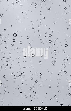 Rain water drops  on clear window.  Natural Pattern of raindrops. Autumn  depressive background. Stock Photo