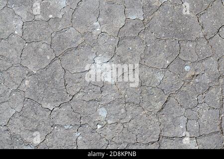 Dry cracked background of volcanic ground turned into desert. Natural abstract texture in crater of active volcano. Stock Photo