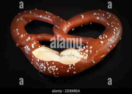 Pretzel with salt on a black background. Close up image Stock Photo