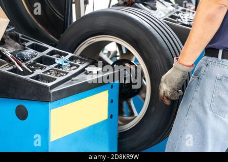 Series of worker balancing tire with wheel balancing machinery Stock Photo