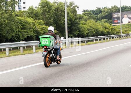 KUALA LUMPUR, MALAYSIA, September 17, 2019: Grabfood ordered online being delivered on motorbike by grab rider. Grabfood is a fastest growing food Stock Photo