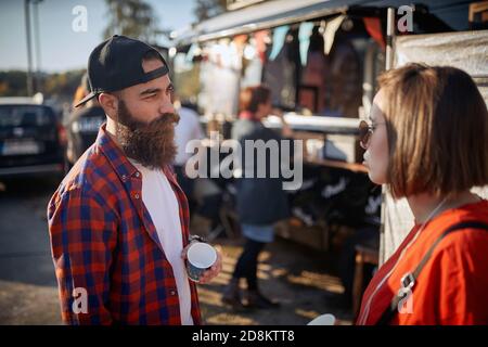 young hipster having a conversation with a cool female, wearing sunglasses Stock Photo