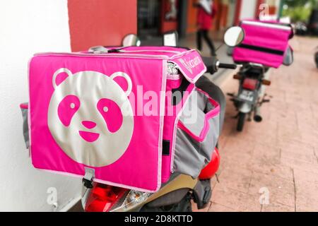 KUALA LUMPUR, MALAYSIA, September 17, 2019: Foodpanda riders waiting outside restaurants for food delivery services assignment. Foodpanda is a up and Stock Photo