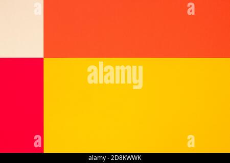 Abstract geometric bright multicolor paper flat lay background consisting of 4 sheets of different shades - beige, yellow, orange and red. Stock Photo