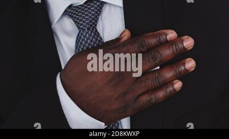 African american black businessman holding hand on his chest. High quality photo Stock Photo