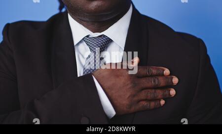 African american black businessman holding hand on his chest. High quality photo Stock Photo